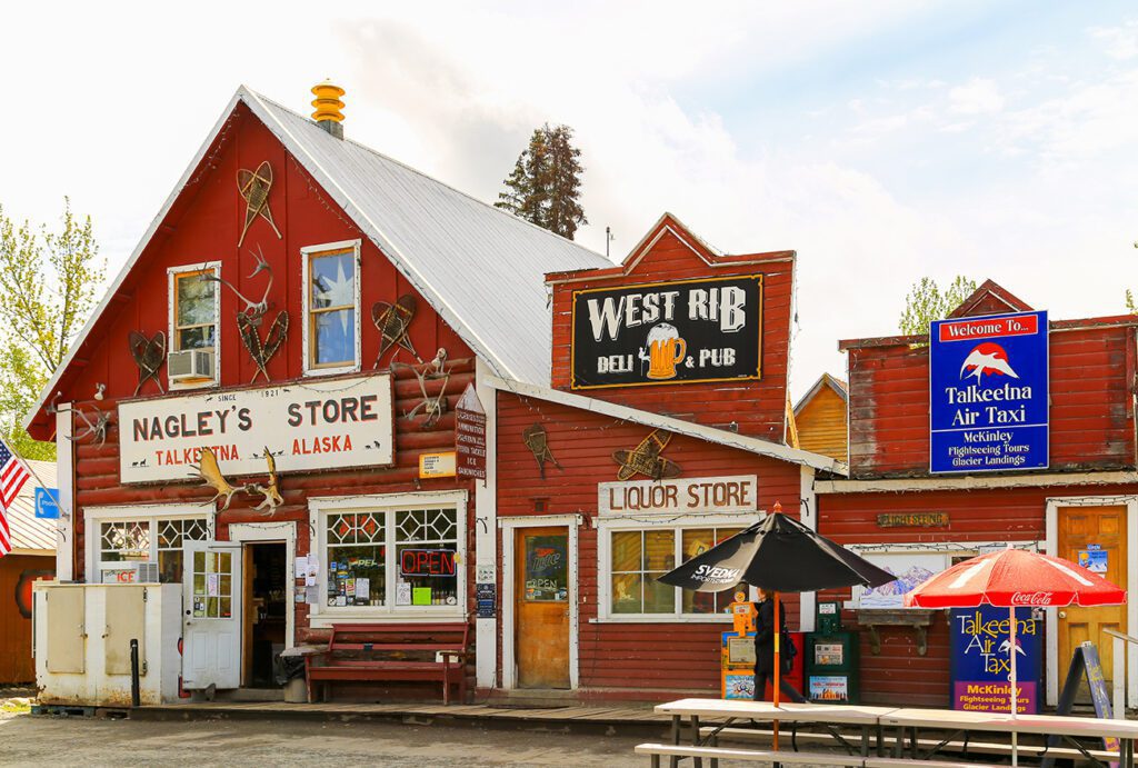 Facade of stores and pubs in the small oldtown of Talkeetna, Alaska. Residents and Tourists come here to get food, gifts and other goods.